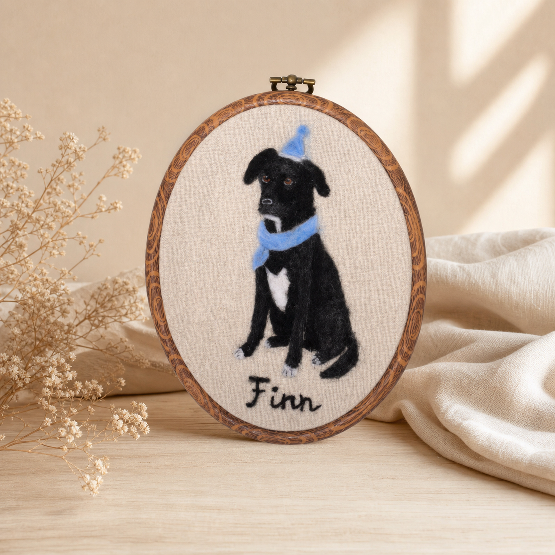Finn, a black dog, recreated as a wool felt portrait